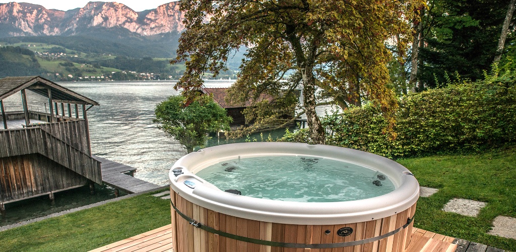 Hot tub overlooking a lake at sunset